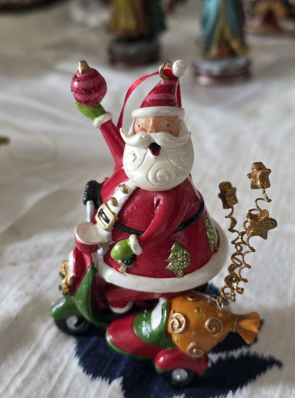 whimsical resin or ceramic Christmas ornament featuring Santa Clause